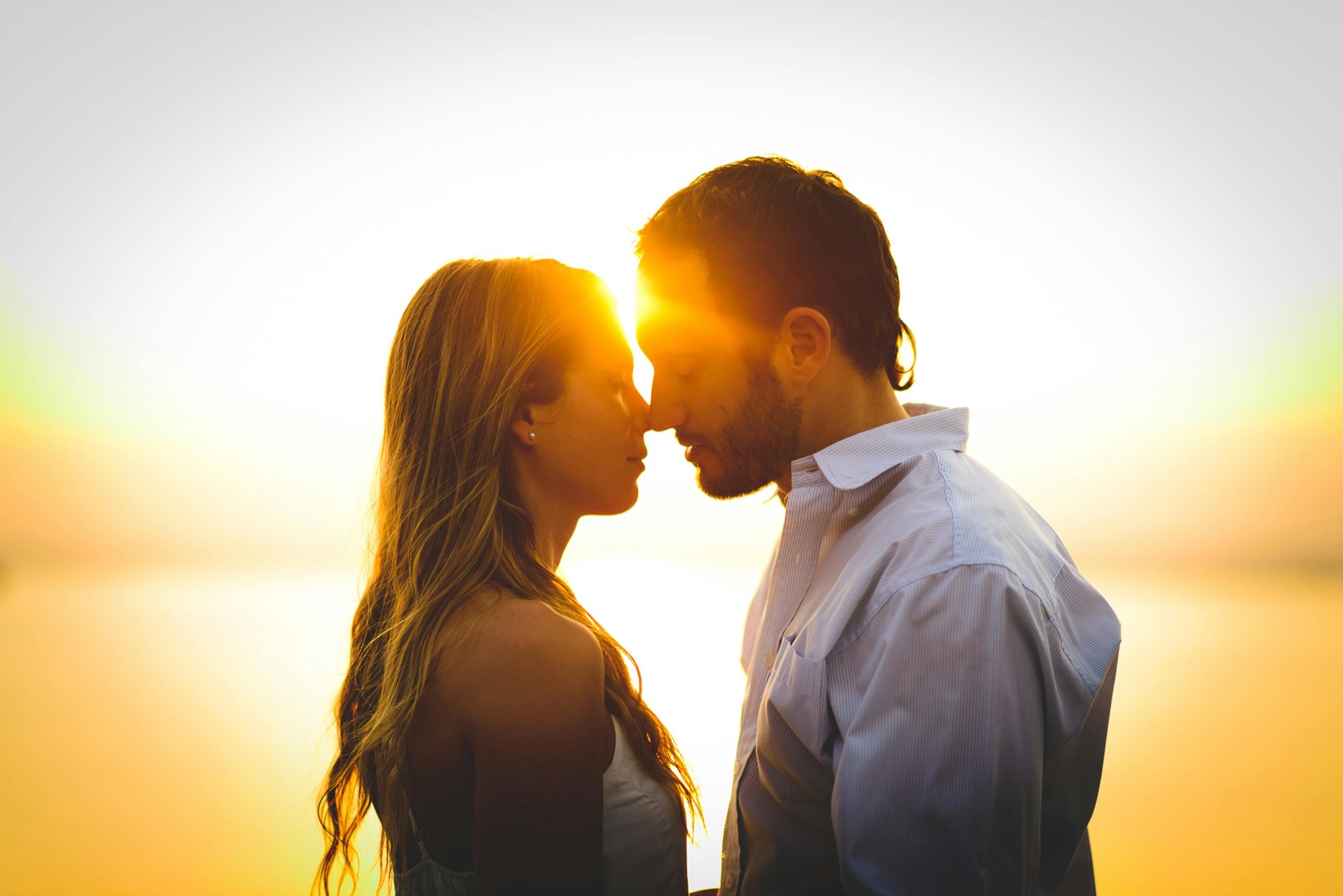 A romantic couple in a sunset embrace near Ottawa, symbolizing meaningful local relationships.
